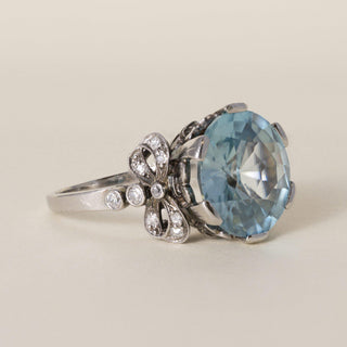 Antique Edwardian Platinum 7 Carat Blue Zircon Round Cut Ribbon Diamond Ring